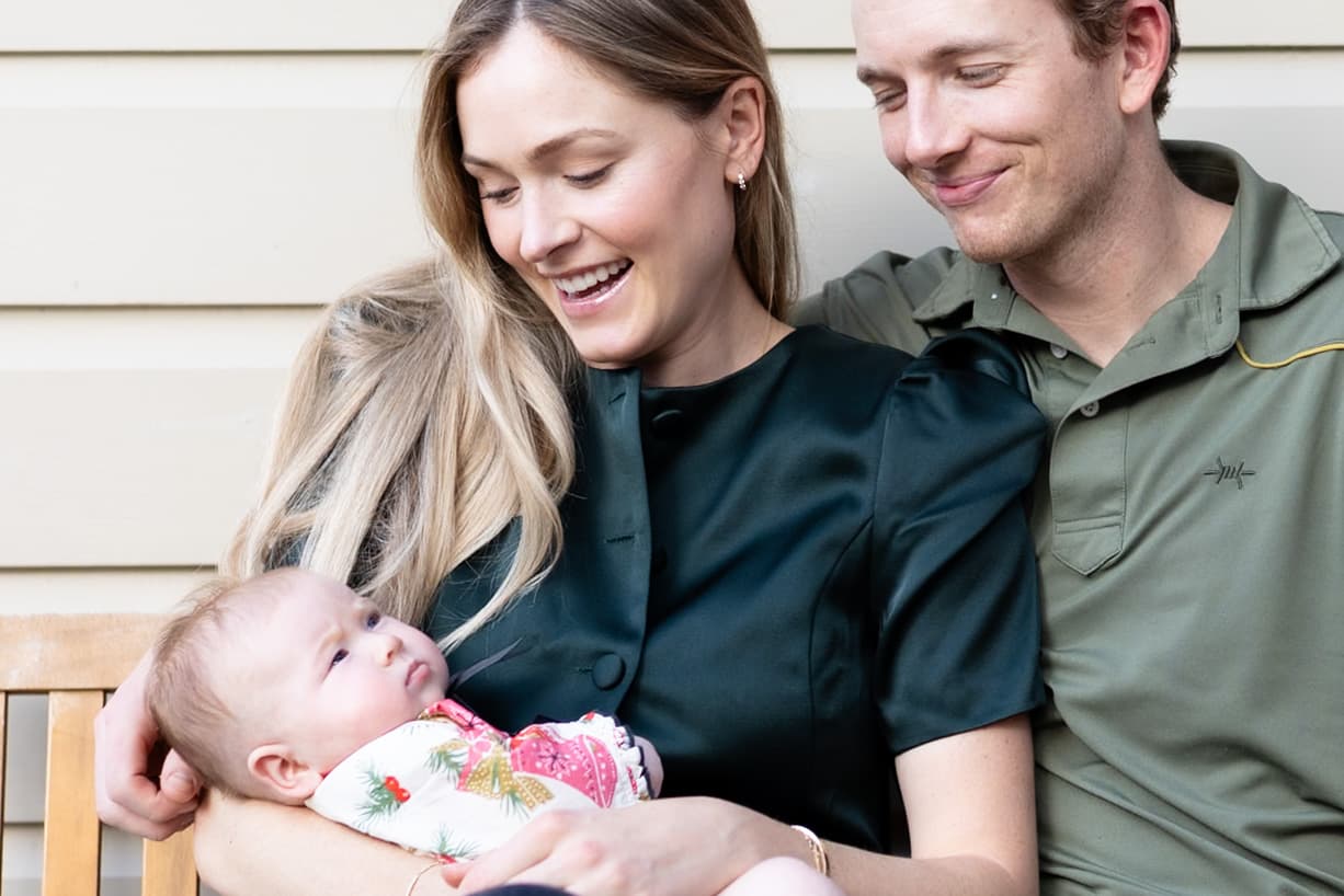 Family with newborn on the porch